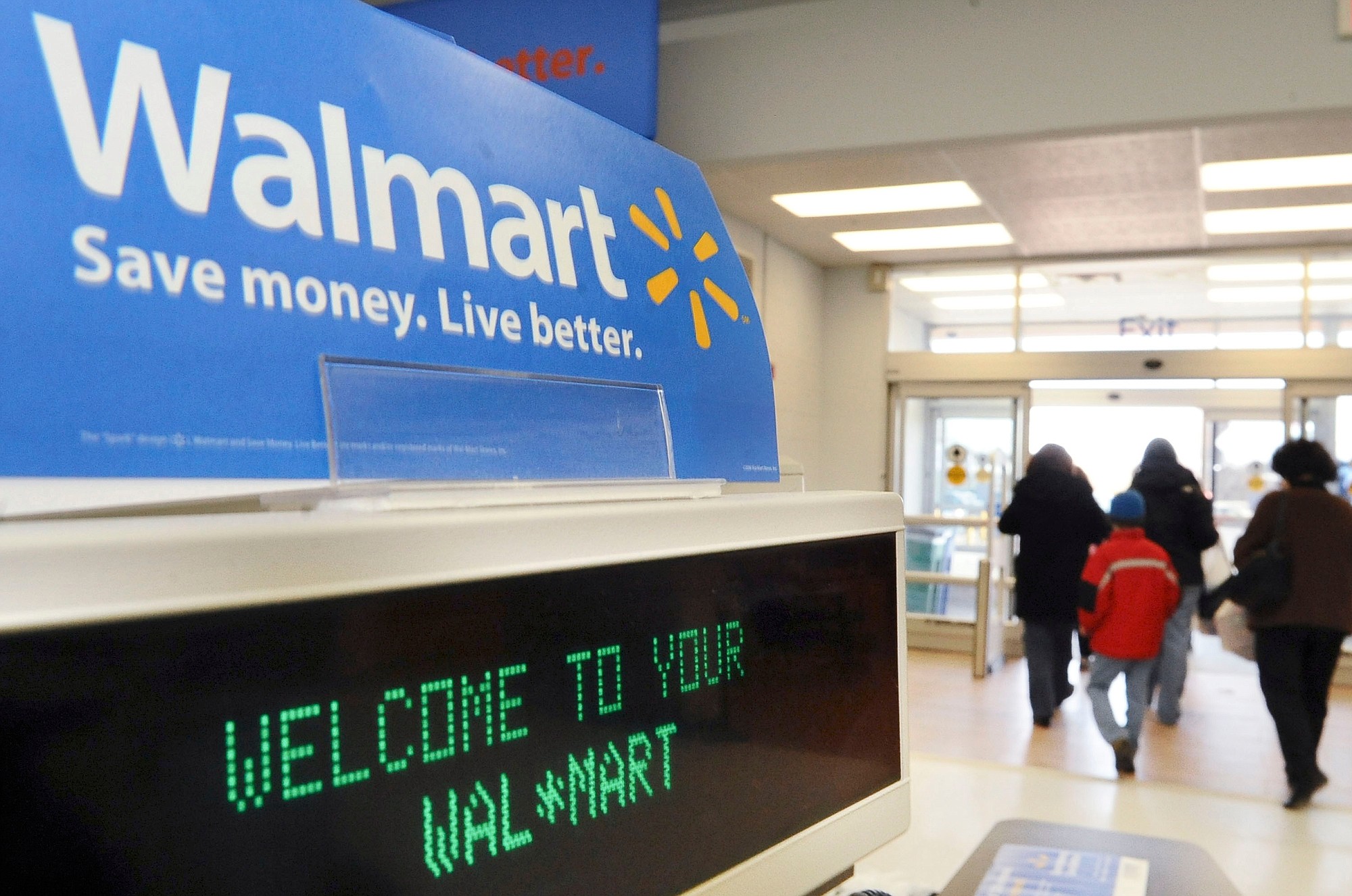 Shoppers leave a Wal-Mart in Danvers, Mass.