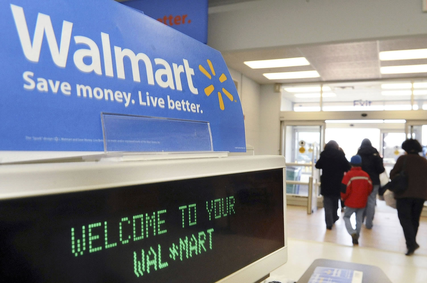 Shoppers leave a Wal-Mart in Danvers, Mass. Wal-Mart is raising starting wages for more than 100,000 U.S.
