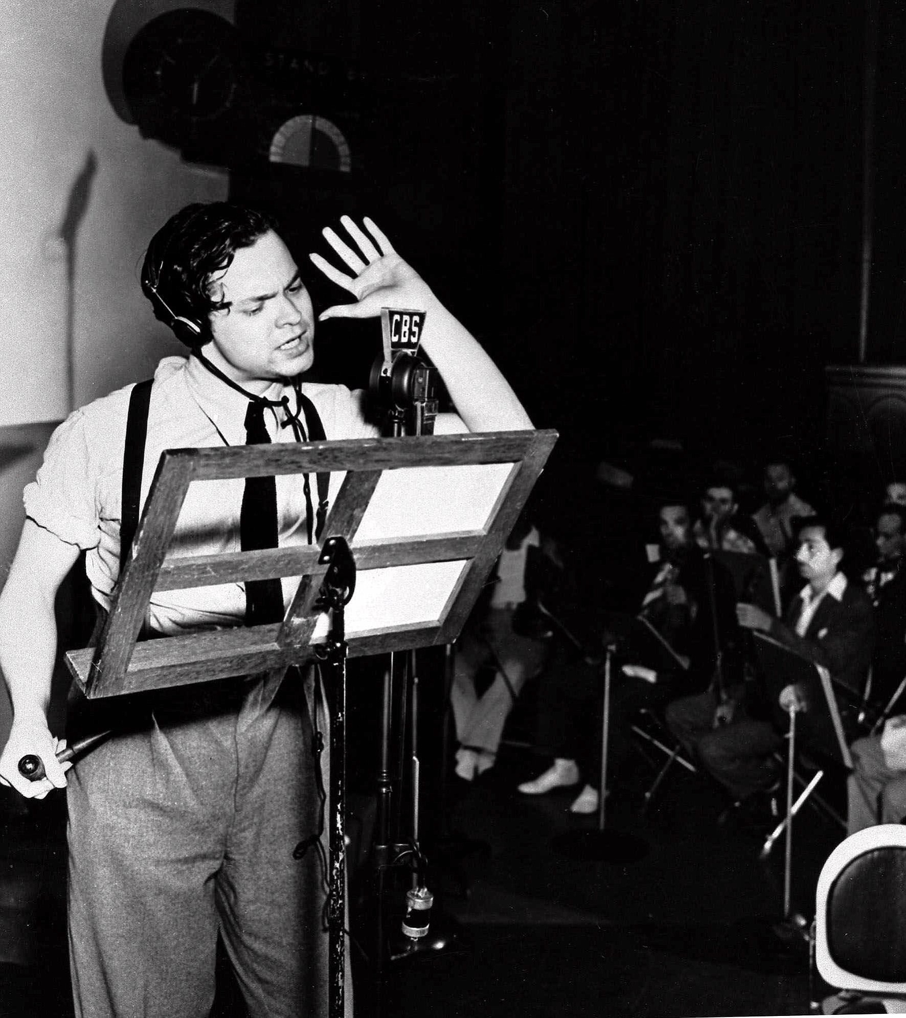 Orson Welles reads from his script during the 1938 broadcast his radio show &quot;The War of the Worlds.&quot; Wells' fictional account of a Martian invasion of Earth created widespread panic in the minds of thousands of listeners.