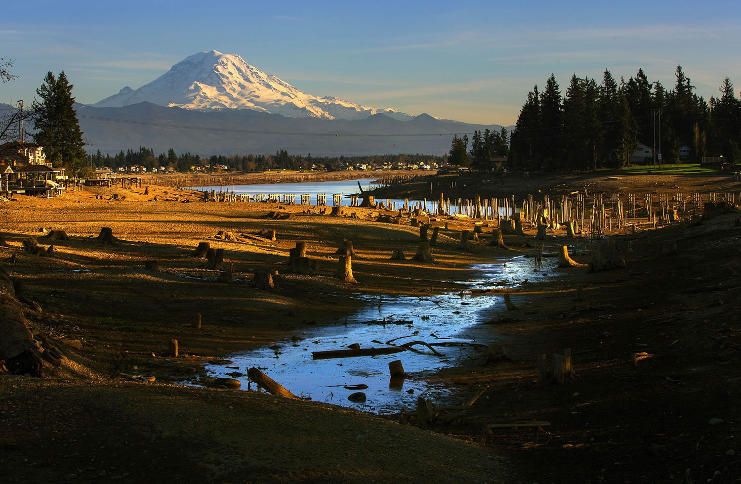 With Mount Rainier in the background, Lake Tapps near Sumner is shown in February with lowered water levels due to maintenance being done by the Cascade Water Alliance, which owns the lake.