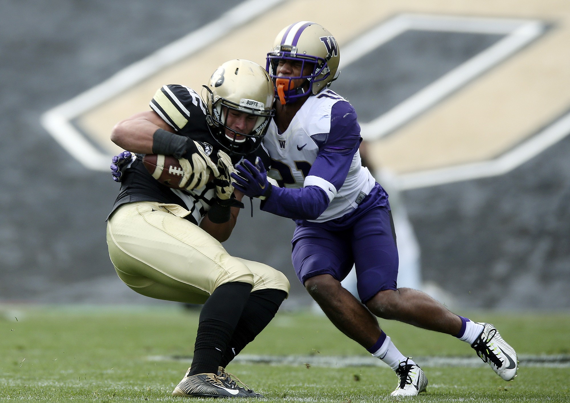 Washington defensive back Marcus Peters, left, tackles Colorado wide receiver Nelson Spruce during a game Saturday, Nov. 1, 2014. Peters has since been dismissed from the Huskies.