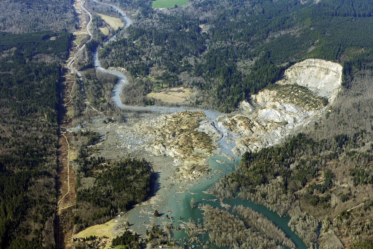 The massive mudslide that killed 43 people in the community of Oso is shown from the air March 24, 2014. The community will mark the one-year anniversary of the slide on Sunday. (AP Photo/Ted S.