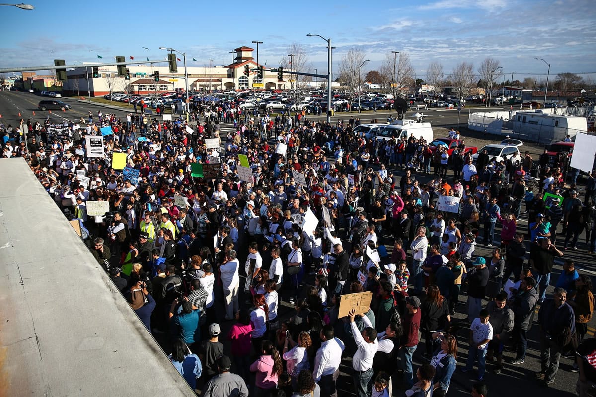 People gather near a memorial Saturday during a rally for Antonio Zambrano-Montes in Pasco. Zambrano-Montes was shot and killed by Pasco police Feb.