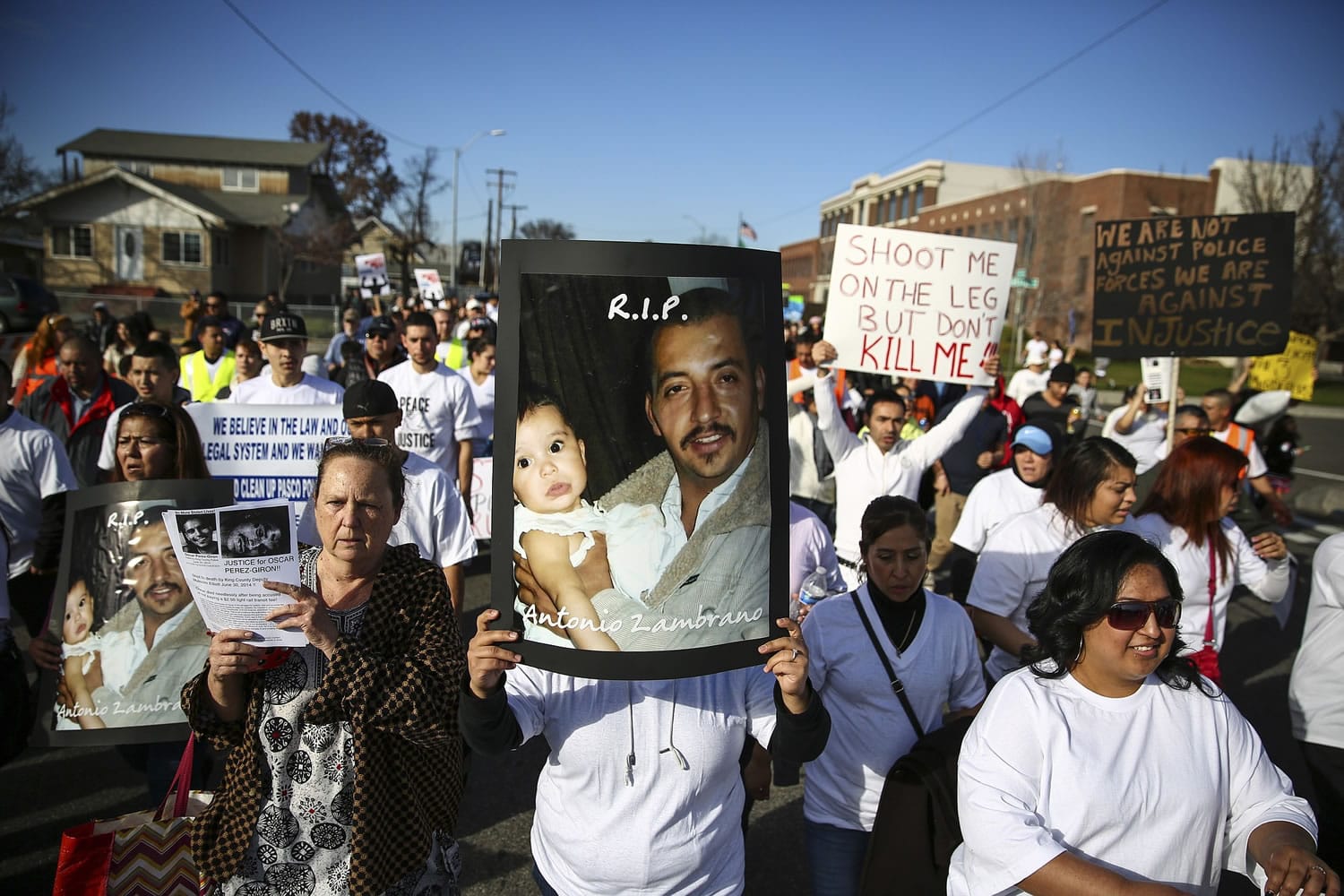 Marchers carry photos of police shooting victim Antonio Zambrano-Montes during a Feb. 14 rally in Pasco. The parents of Zambrano-Monte have filed a $4.76 million claim against the city of Pasco.