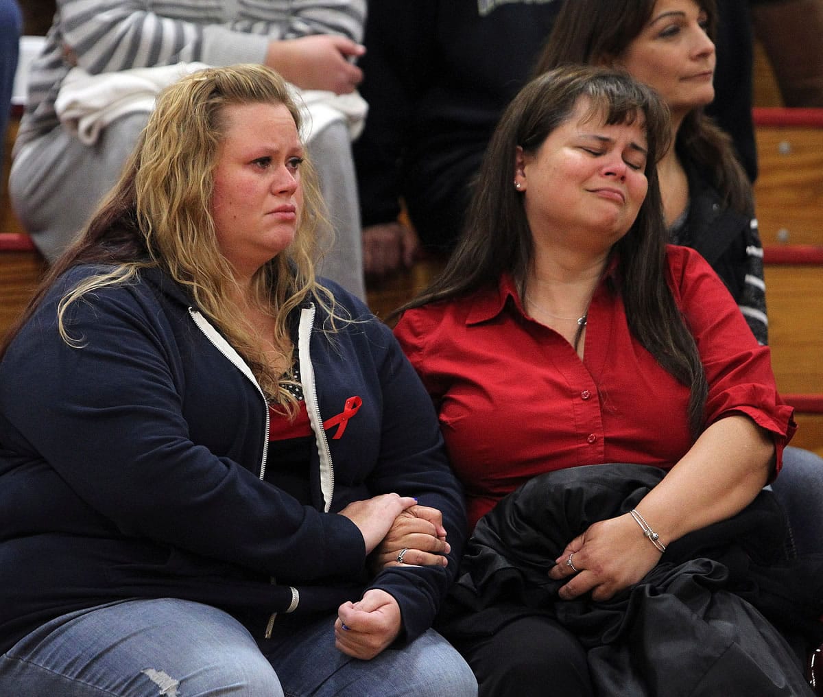 JoDonna Hansen, left, and Paula Dalcour listen during a community meeting at Marysville-Pilchuck High School, Tuesday night, to local school and community officials who spoke and answered questions in the wake of Friday's school shooting.