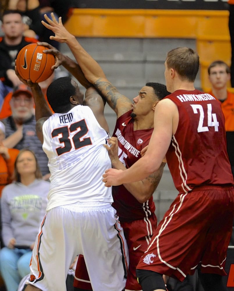 Washington State's Josh Hawkinson (24) and DaVonte Lacy (25) defend against Oregon State's Jamal Reid (32) during the first half in Corvallis, Ore., Thursday, Feb.