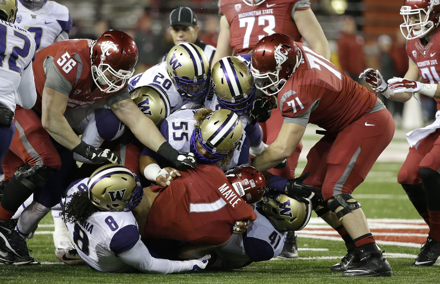 Washington State wide receiver Vince Mayle (1) is tackled by Washington defensive lineman Danny Shelton (55) and a host of other players in the first half Saturday in Pullman.
