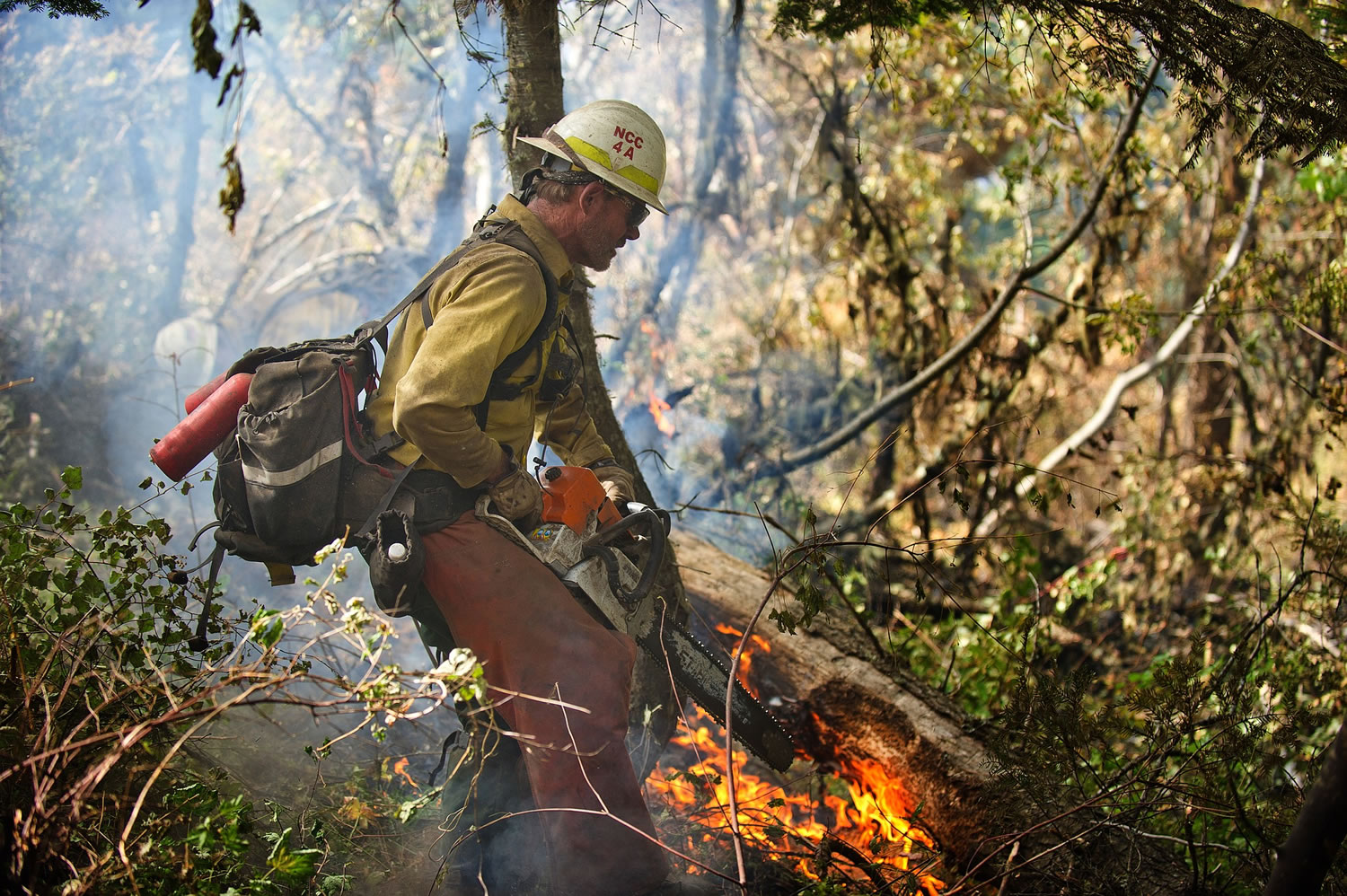 A firefighter works to extinguish a hot spot in the Blue Creek Fire on Sunday near Walla Walla.