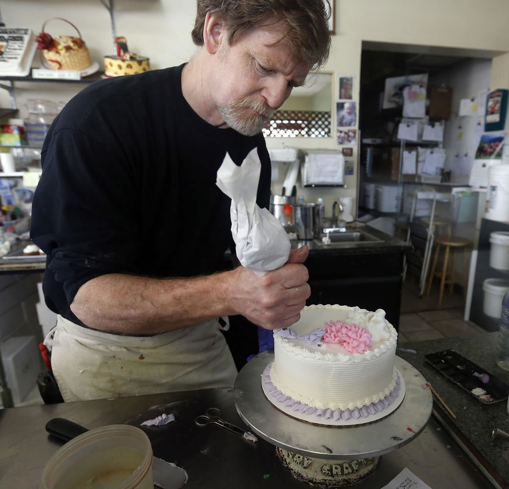 Masterpiece Cakeshop owner Jack Phillips decorates a cake inside his store in Lakewood, Colo., on March 10, 2014.