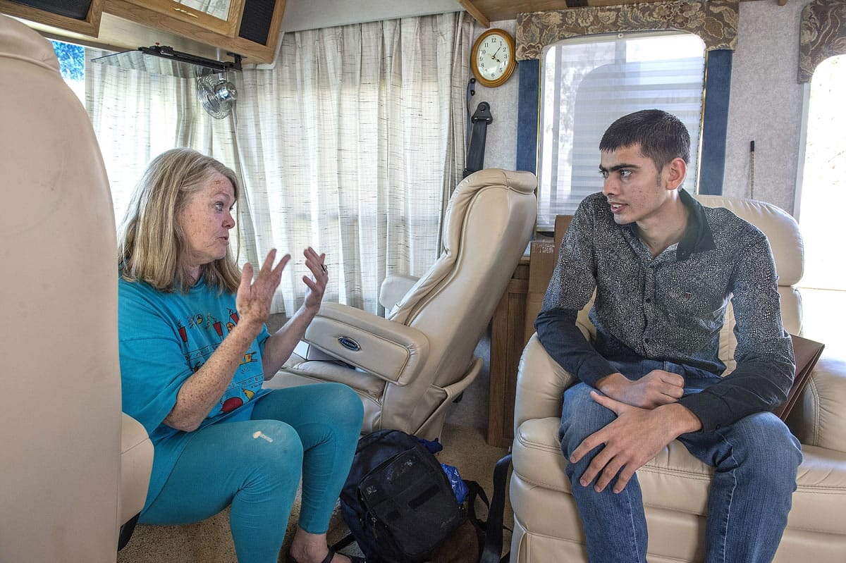 Peggy Herman, an immigration lawyer from Seattle, works to overcome a language barrier to help Jaskarn Singh, right, a 21-year-old Indian national seeking political asylum in the U.S.