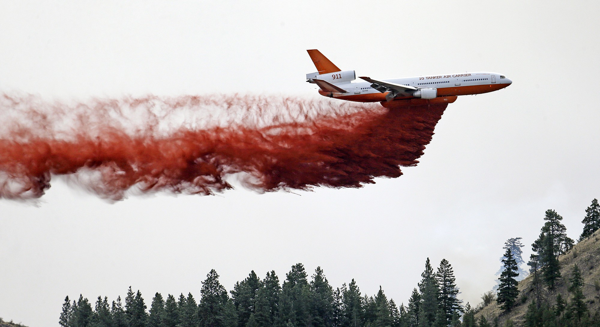 A DC-10 air tanker drops fire retardant over a wildfire Saturday near Carlton.