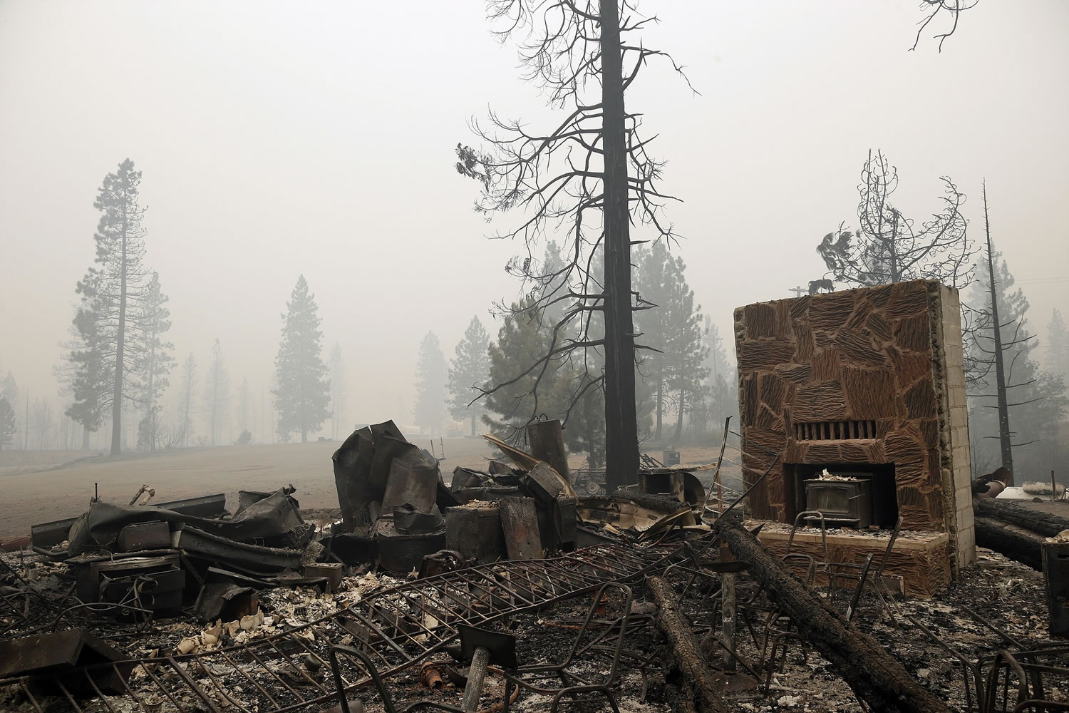 A structure burned down by the Eiler Fire is seen along the main road into town on Monday in Hat Creek, Calif.
