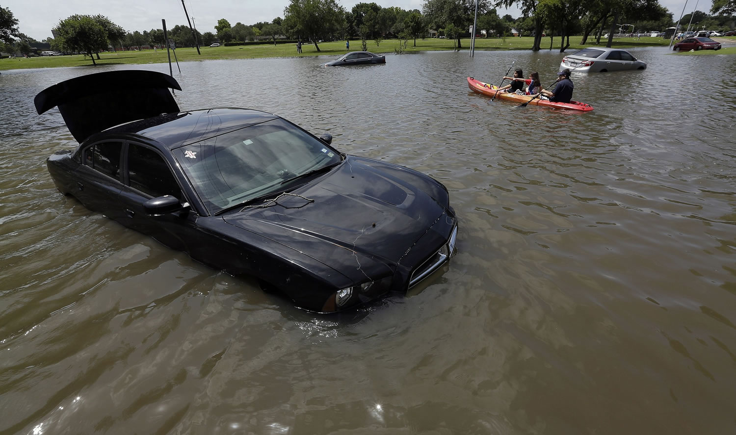 A boat is paddled down a flooded street in May in Houston. Federal officials calculated that last month was the wettest on record for the contiguous U.S. On average 4.36 inches of rain and snow fell over the Lower 48 in May, sloshing past October 2009 which had been the wettest month in U.S. records with 4.29 inches. Records go back to 1895.