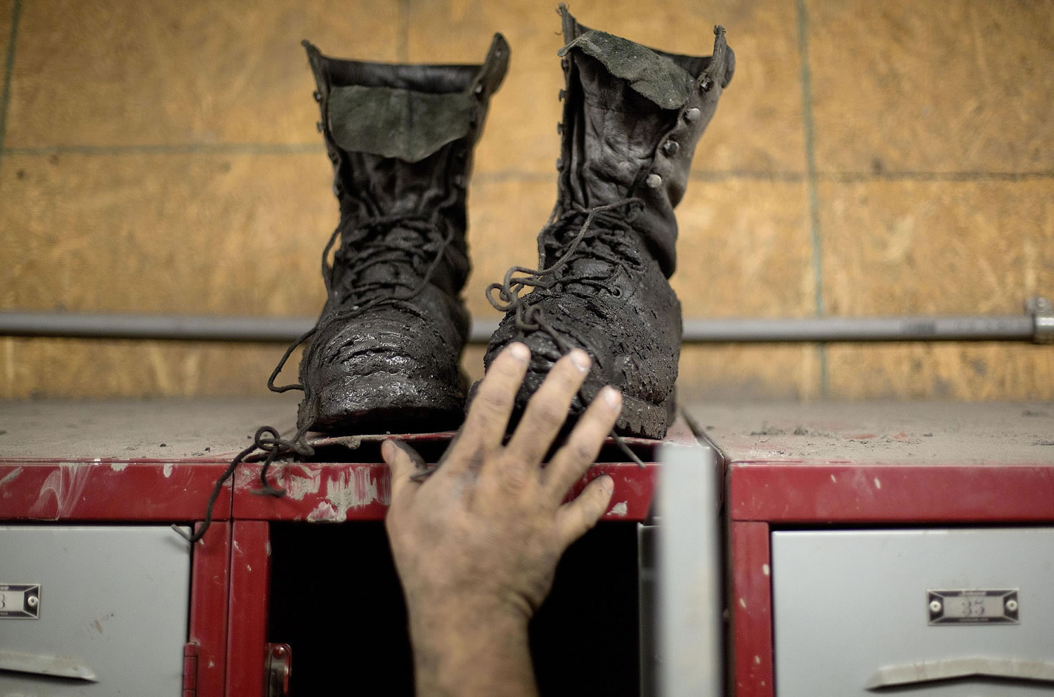 Coal miner Johnny Turner, 35, puts his coal boots on top of his locker after finishing a shift at the Perkins Branch coal mine in Cumberland, Ky., on Oct. 15.