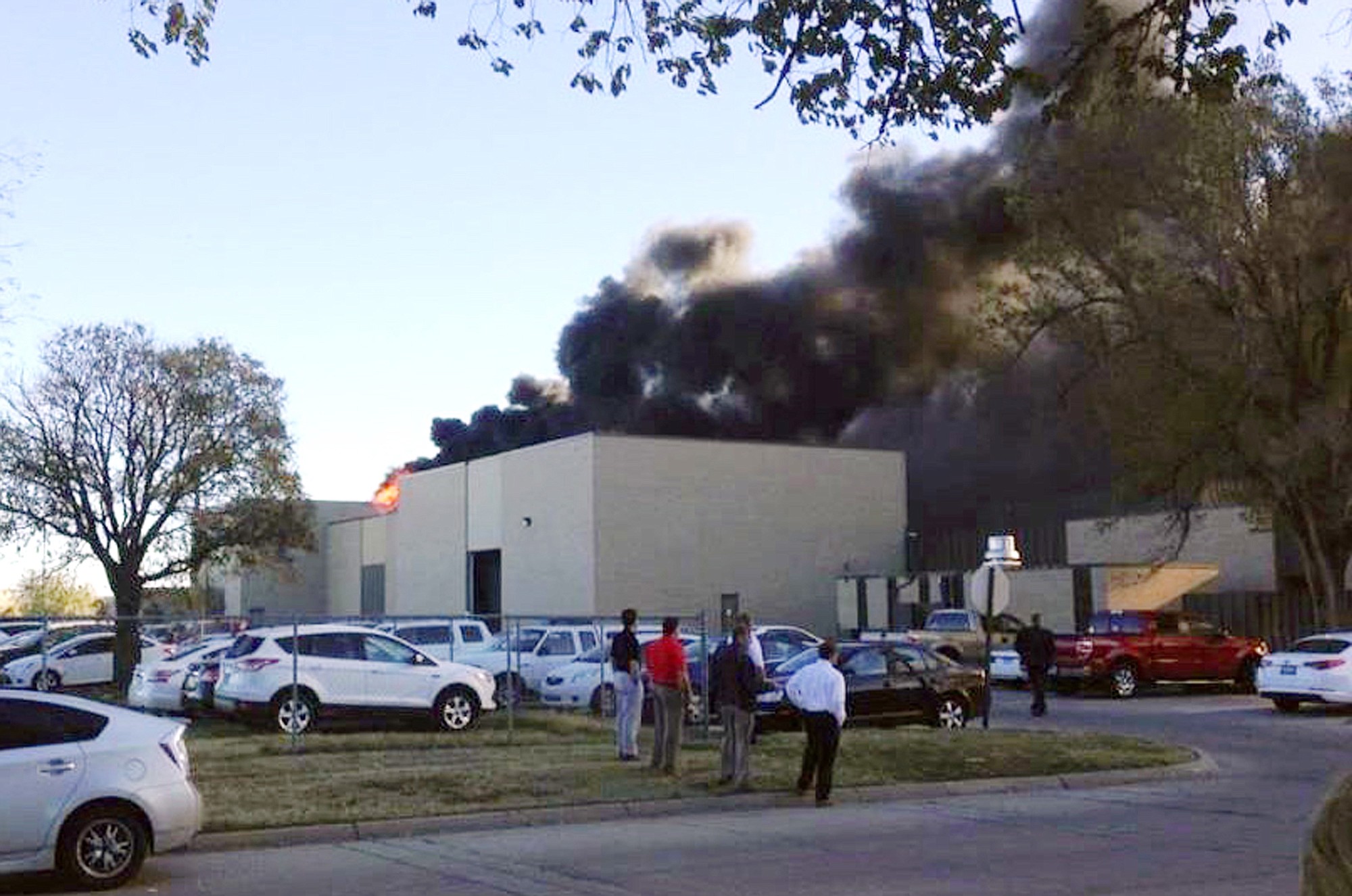 In the image from video provided by KAKE News, black smoke billows from a building at Mid-Continent Airport where officials say a plane crashed Thursday, in Wichita, Kan.