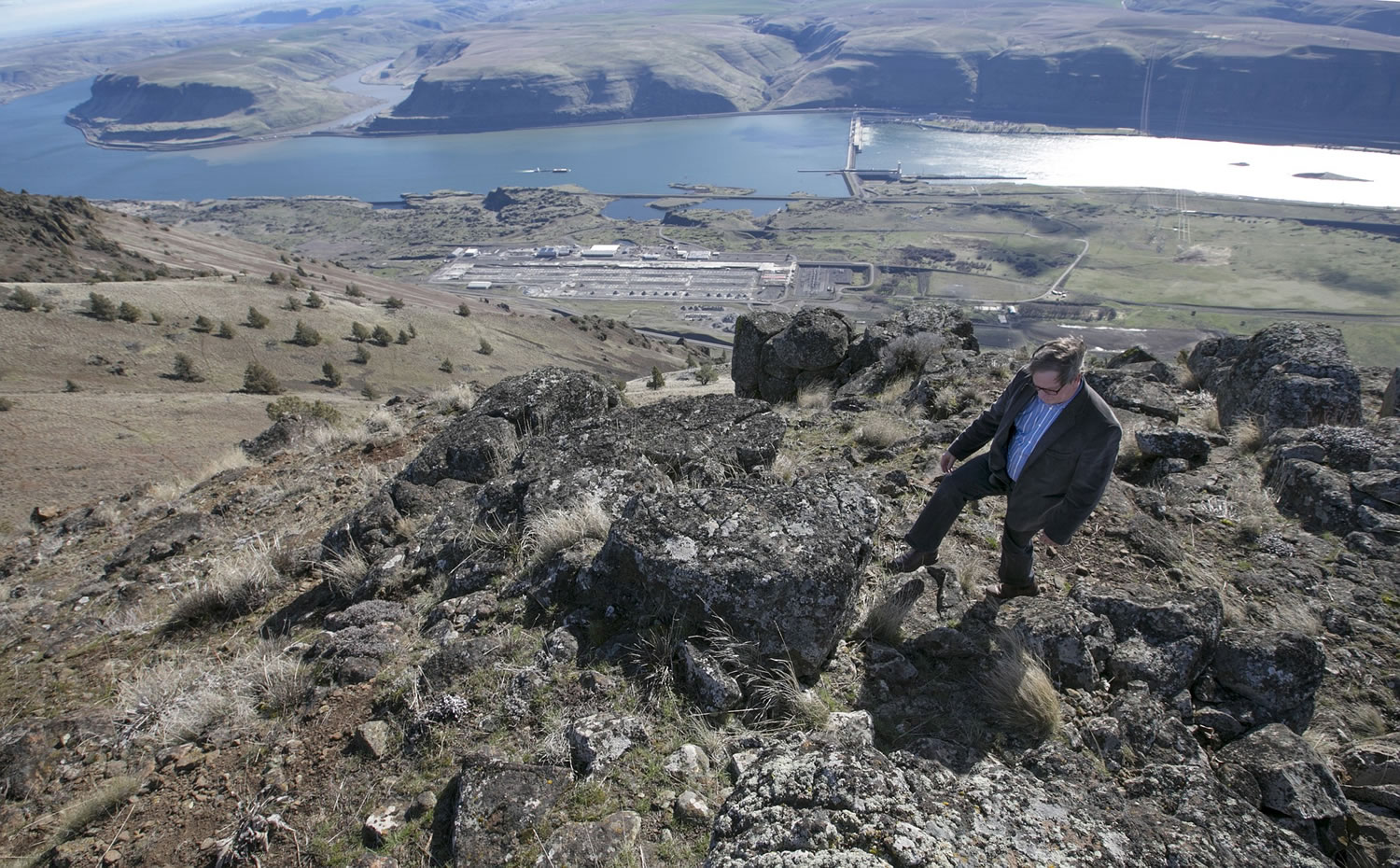 Gordon King/Yakima Herald-Republic
Randy Knowles, a Klickitat utility commissioner, walks back from a rocky outcrop overlooking the landscape east of Goldendale.