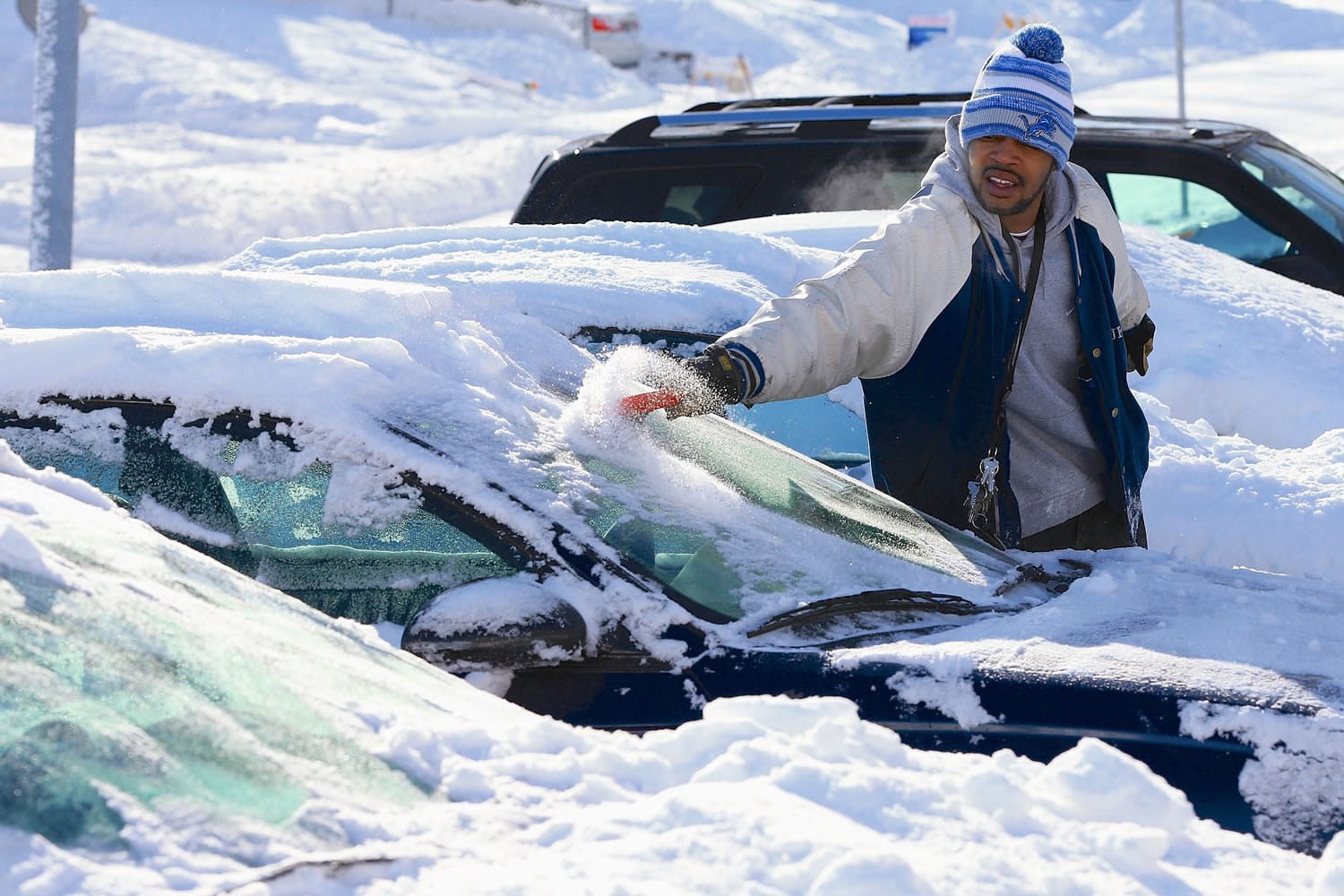 Nikita Smith removes snow and ice from his car Monday in Omaha, Neb., after a winter storm dumped around 9 inches of snow over the weekend.
