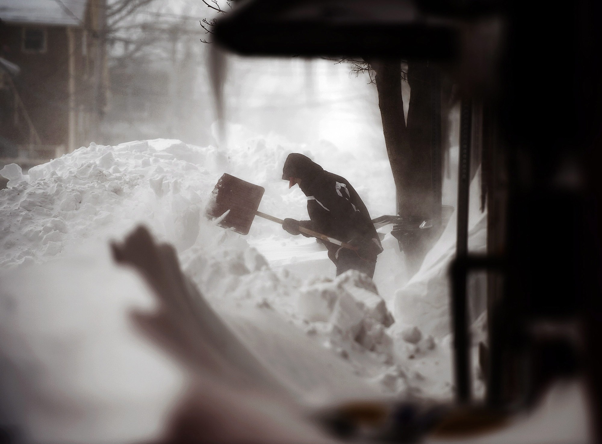 A man clears a sidewalk in downtown Charlottetown, Prince Edward Island, on Monday.
