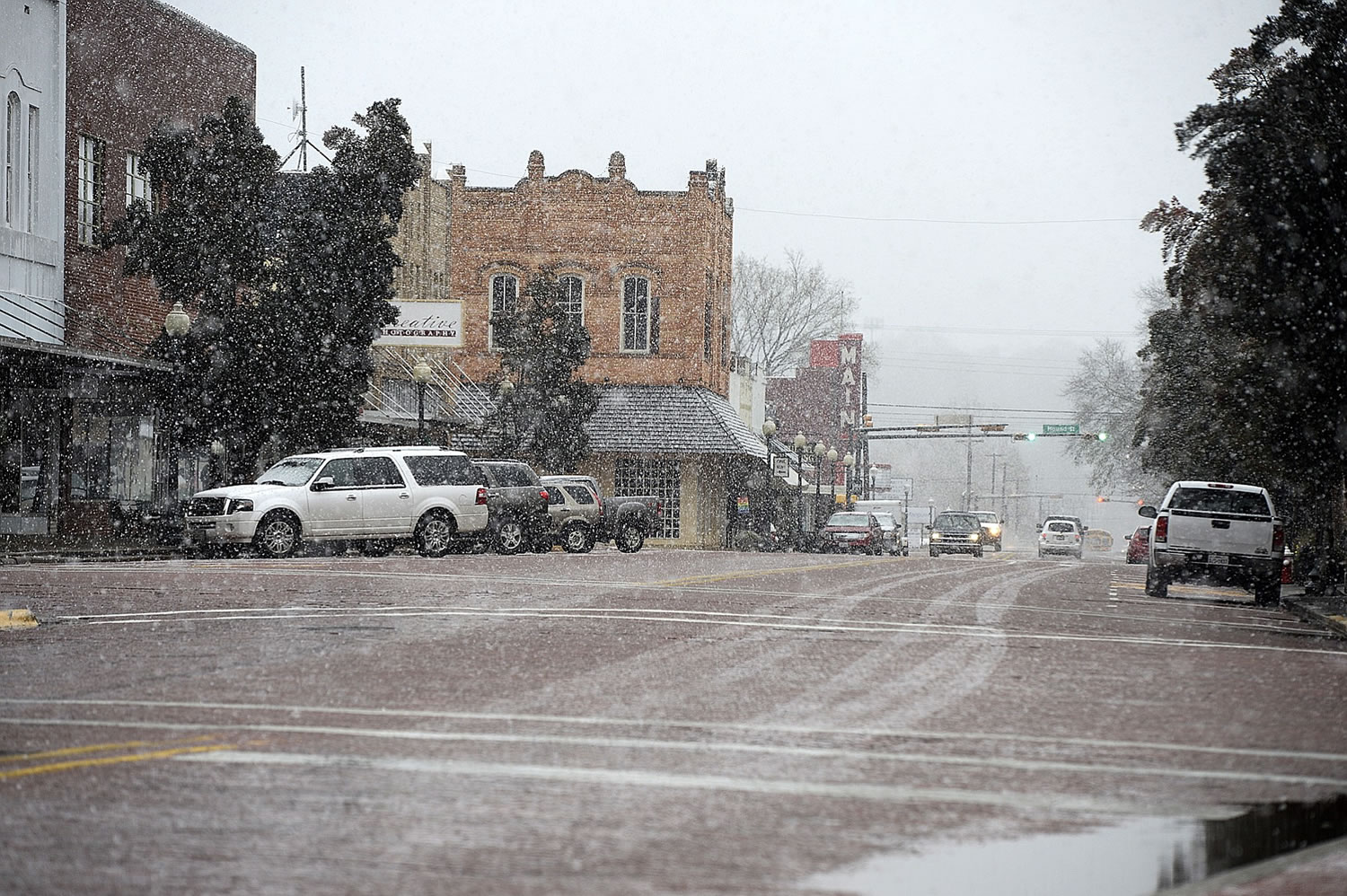 Falling snow blankets East Main Street on Wednesday, in Nacogdoches, Texas.