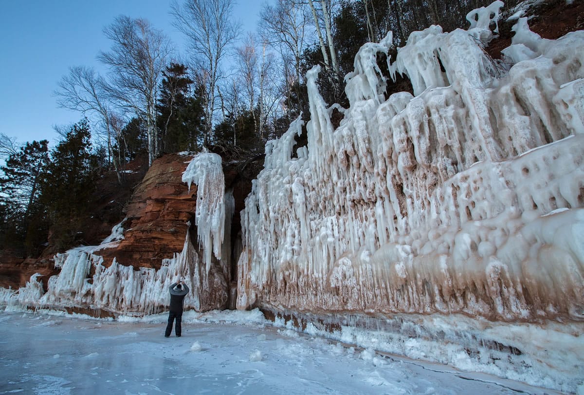A person explores an ice cave at the Apostle Islands National Lakeshore on Lake Superior on Friday near Bayfield, Wis.