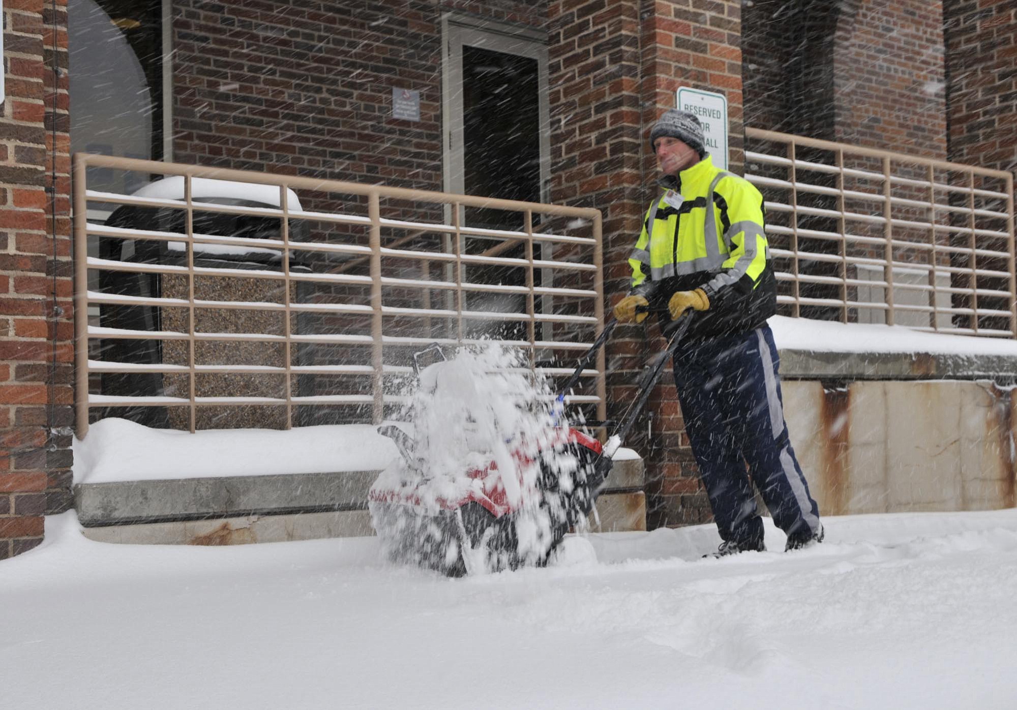 Scott Ringwelski of St. Cloud Hospital's maintenance crew clears the sidewalks Monday morning. St. Cloud, Minn., received more than 2 inches of snow by 6 a.m.