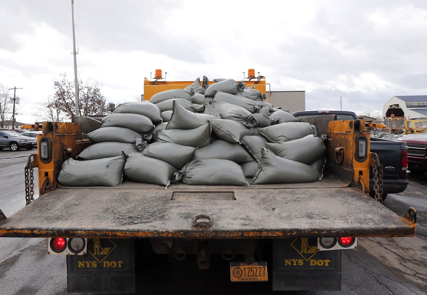 Sand bags are piled on a truck at the West Seneca Highway Department on Monday in West Seneca, N.Y., that were prepared for deployment for potential flooding from melting snow after last week's lake-effect snowstorms.