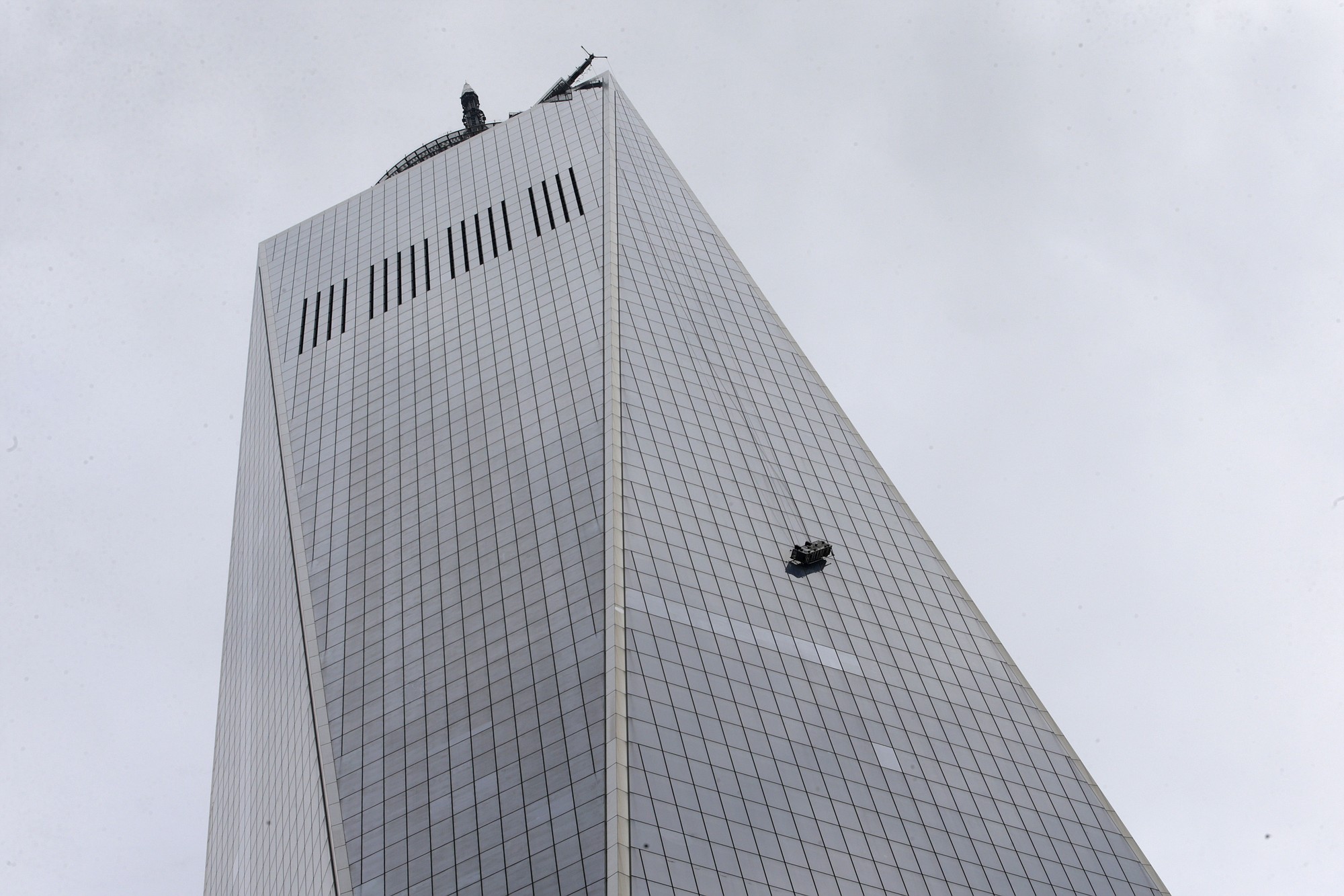 A partially collapsed scaffolding hangs from the 1  World Trade Center in New York, Wednesday, Nov. 12, 2014. New York City firefighters have been called to the nation's tallest skyscraper, where two workers are stuck on scaffolding 69 stories above street level.