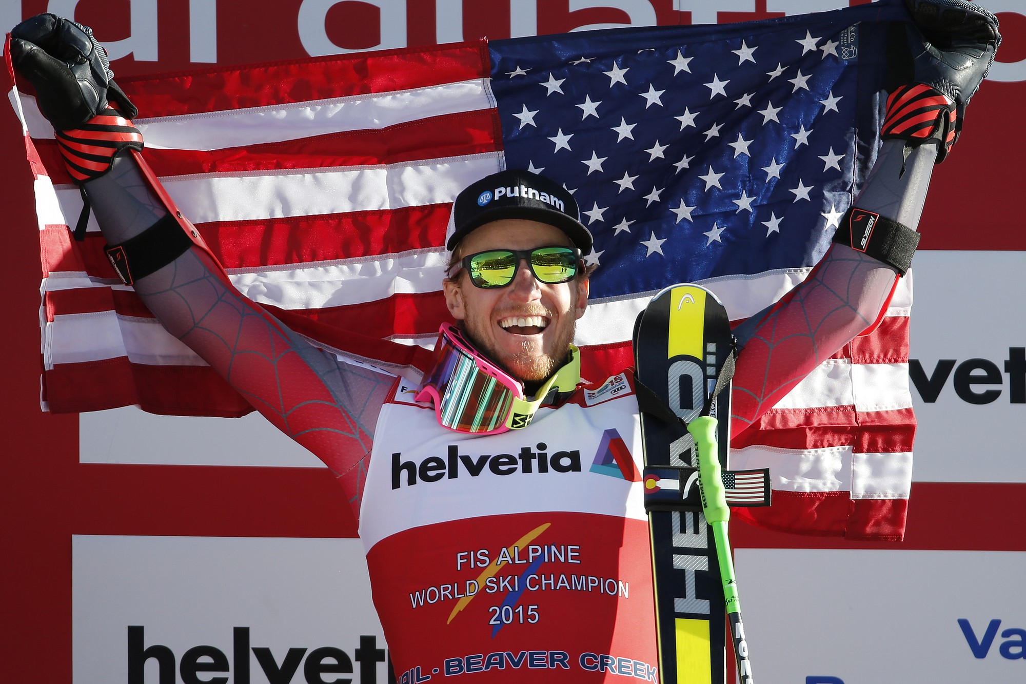 United States' Ted Ligety holds a flag after winning the men's giant slalom at the alpine skiing world championships Friday, Feb. 13, 2015, in Beaver Creek, Colo.