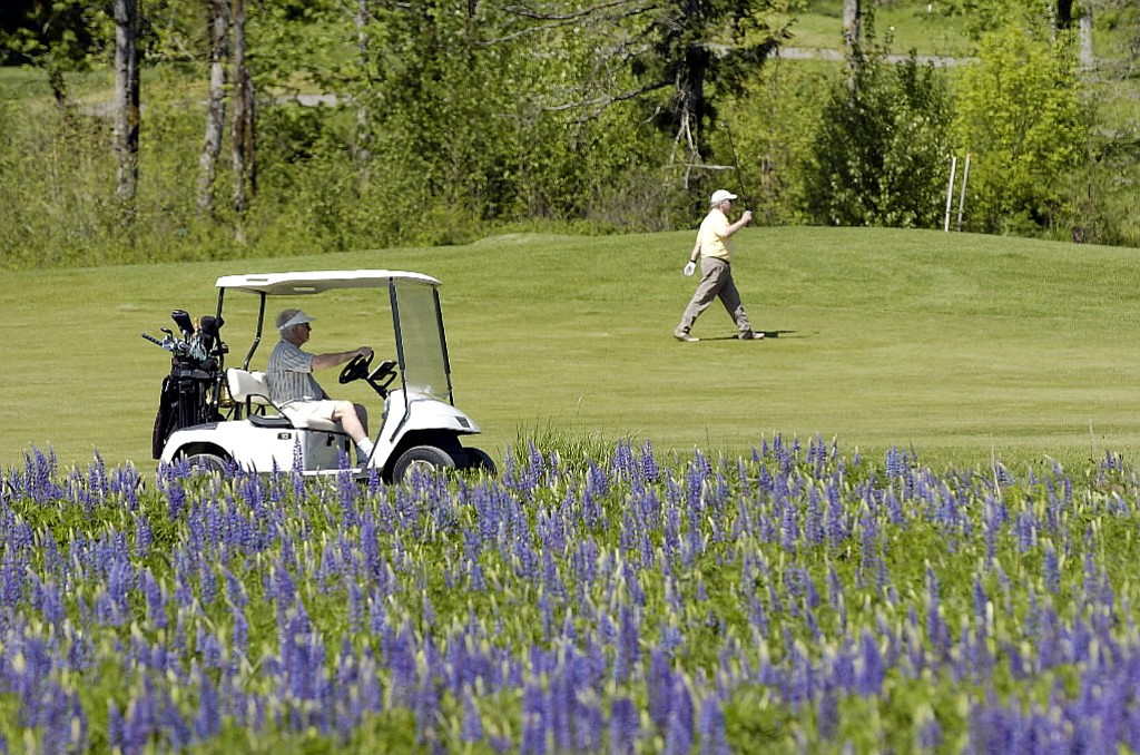 Golfers make their way along the fairway on the 10th hole at the Green Mountain Golf Course.