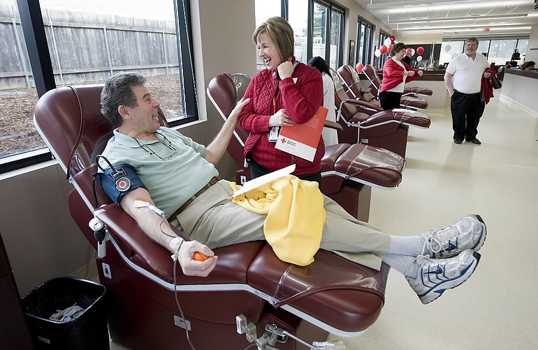 David Garstin, from Vancouver, talks with Daphne Mathew, Communications Manager for the American Red Cross Pacific Northwest Blood Services Region, during the grand opening of the new Clark County Blood Donor Center on March 21, 2009.