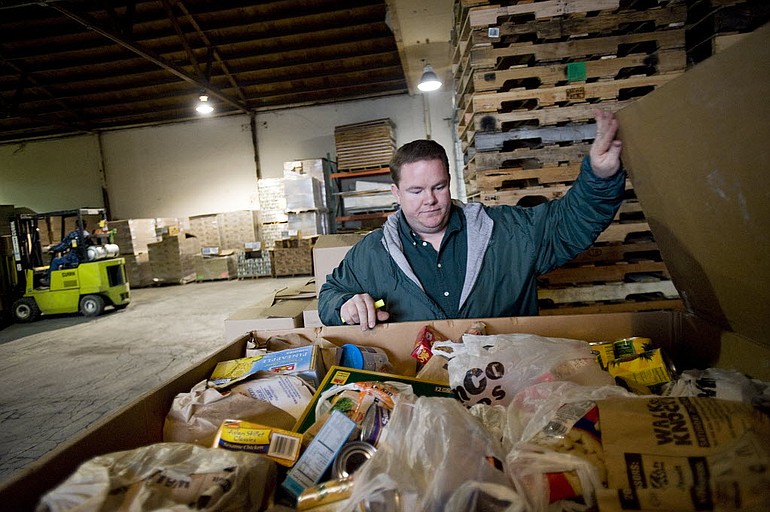 James Fitzgerald, manager of the Stop Hunger Warehouse, starts the process of sorting through food donated during the Walk and Knock food drive in December 2010.