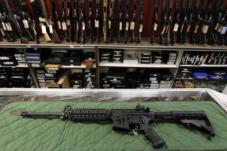 An AR-15 style rifle is displayed at the Firing-Line indoor range and gun shop in Aurora, Colo.