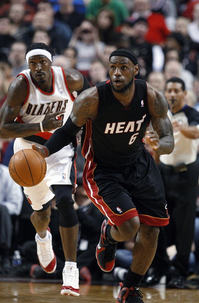 Miami Heat's LeBron James (6) brings the ball up as Portland Trail Blazers' Gerald Wallace follows during the second quarter Thursday.