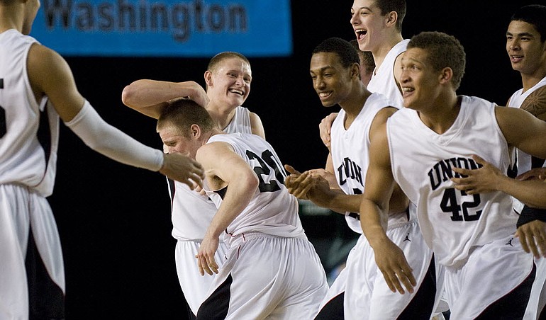 Union celebrates after beating Jackson in overtime at the Class 4A State Basketball Tournament in Tacoma on  Thursday.