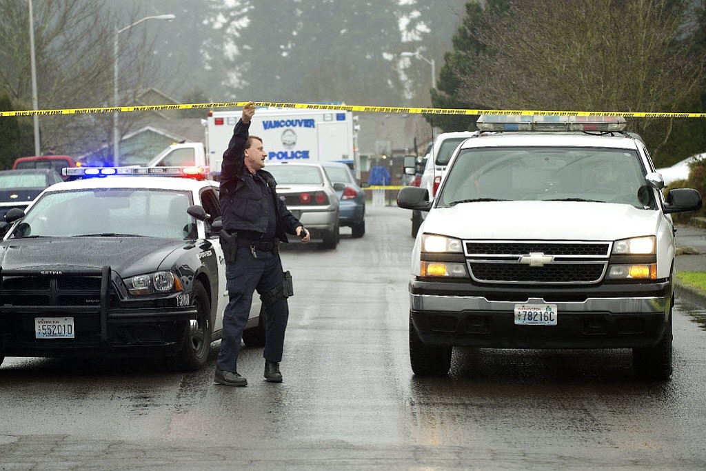 A Vancouver police officer provides assistance during an investigation of a fatal shooting at 14802 N.E. 33rd St. on Jan.