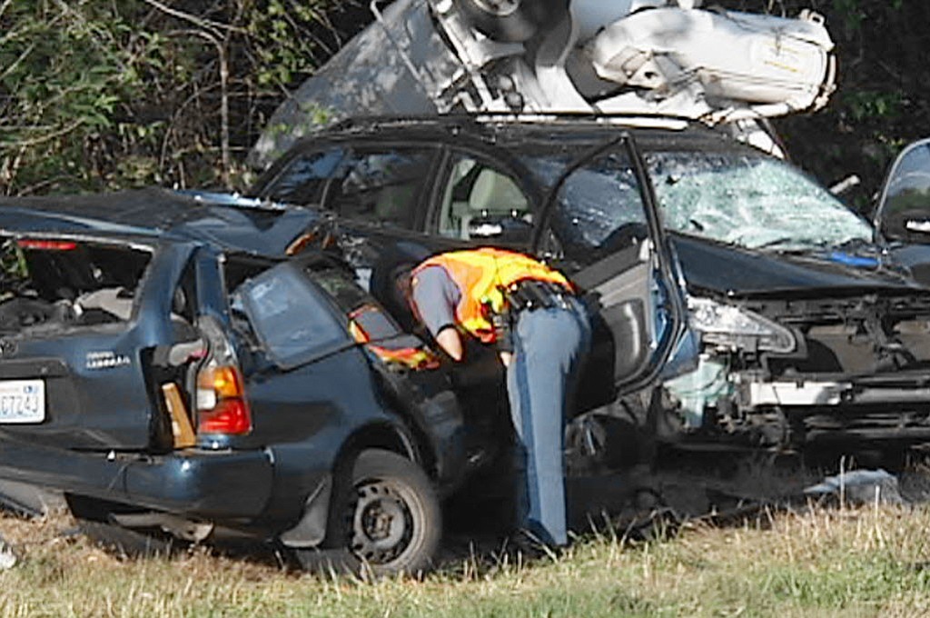 A trooper inspects cars crushed in a collision with a cement truck in Camas.