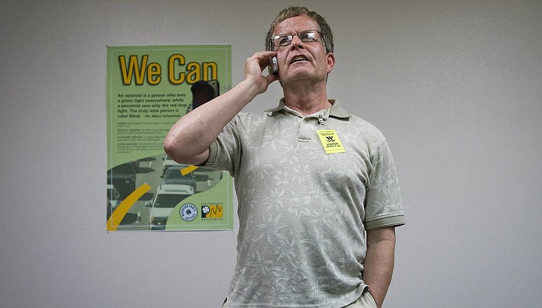 Neil Sullivan, after winning $6.8 million in Washington's Lottery and giving a press conference, takes a call from his new financial adviser at the Lottery office in Hazel Dell.
