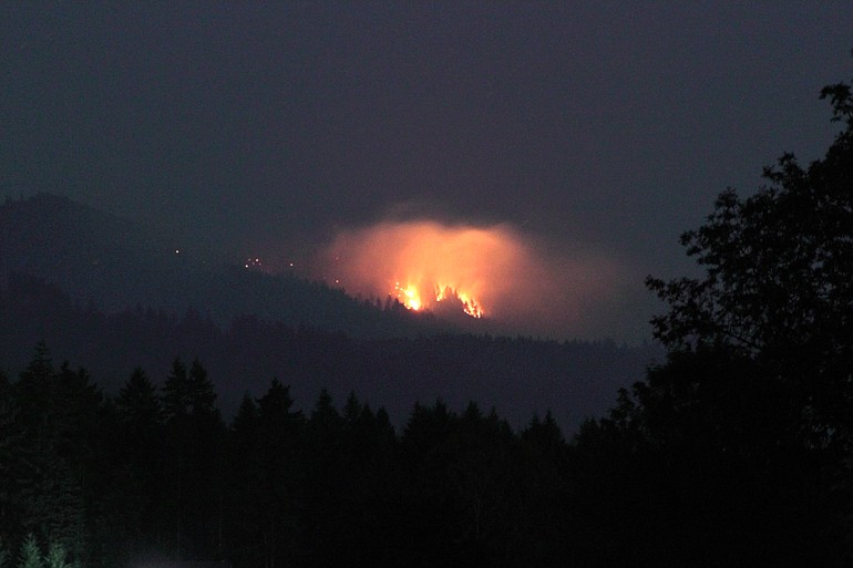 A fire, seen here from entrance of the Hockinson Meadows Park on Saturday night, is burning in the Yacolt Burn State Forest.