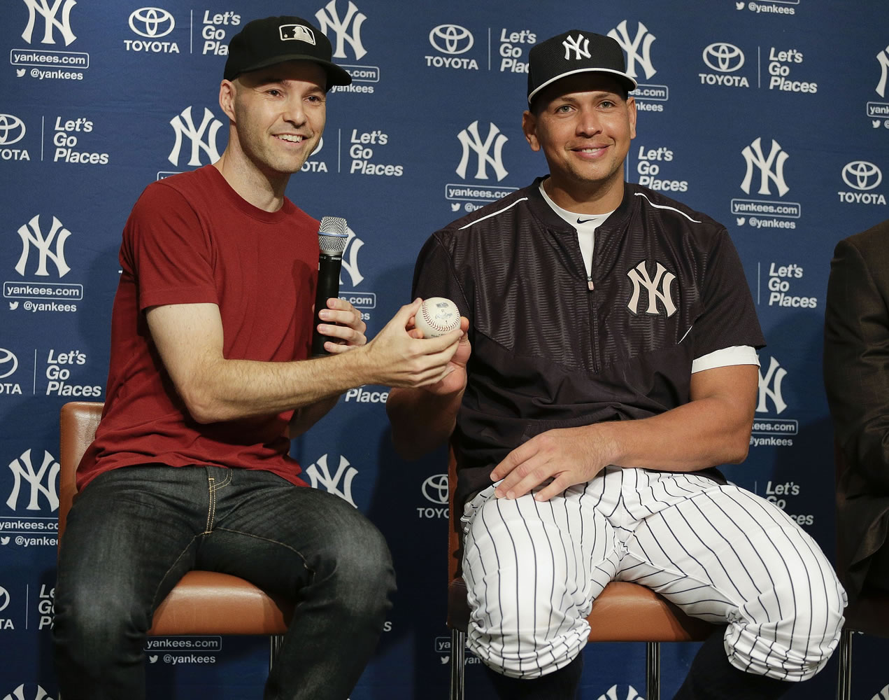 Zack Hample, left, presents New York Yankees Alex Rodriguez with the baseball on which Rodriguez got his 3,000th career hit during a news conference, Friday, July 3, 2015, in New York. Hample caught the ball, which was a solo home run to right field on Friday, June 19, against the Detroit Tigers.