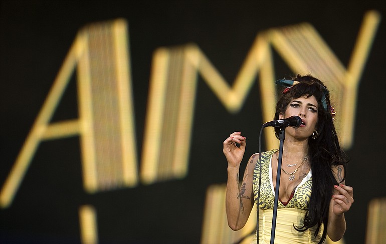In this July 4, 2008 file photo, singer Amy Winehouse of England performs during the Rock in Rio music festival in Arganda del Rey, on the outskirts of Madrid. British police say singer Amy Winehouse has been found dead at her home in London on Saturday.