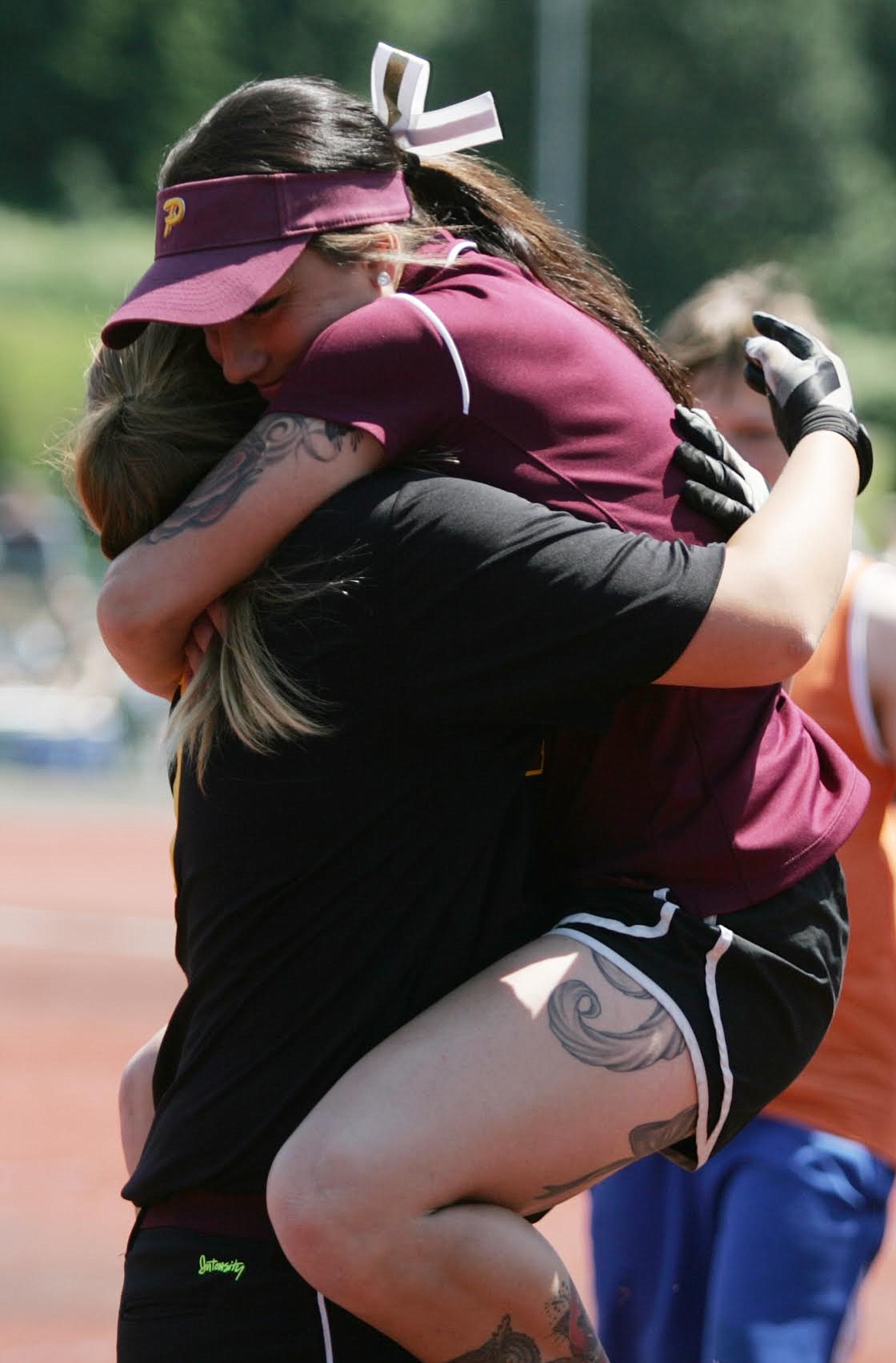 Prairie softball coach Ari Van Horn leaps into the arms of Taylor Ramey after Ramey hit a game-winning, two-run home run that beat Kelso 8-7 in the 3A state tournament (Jim Bryant/For The Columbian)