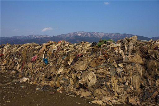 This file photo taken Tuesday Feb. 21, 2012 shows clothing lying in heaps at the site of a neighborhood destroyed by the 2011 earthquake and tsunami, in Rikuzentakata, Japan. Scientists believe ocean waves carried away 3-4 million tons of the 20 million tons of debris created by tsunamis that slammed into Japan after a magnitude-9.0 earthquake nearly a year ago. One-to-two million tons of it _ lumber and other construction material, fishing boats and other fragments of coastal towns _ are still in the water and are being carried across the Pacific by ocean currents.
