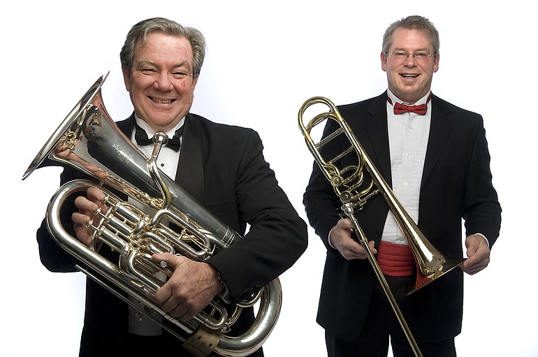 Andy Harris, left, with his euphonium, conducts Big Horn Brass, in which Doug Peebles of the Vancouver Symphony plays his bass trombone.