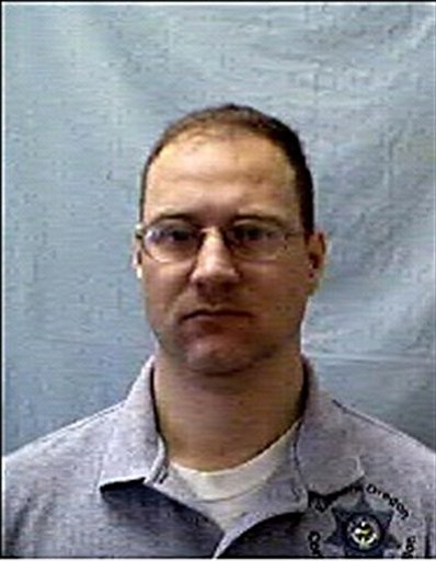 This undated photo provided by the Oregon Department of Corrections shows Buddy R. Herron, a four-year employee of the department and a corrections officer at the Eastern Oregon Correctional Institution in Pendleton, Ore. Herron, 42, was killed Monday after stopping to help a man stranded by a car crash.