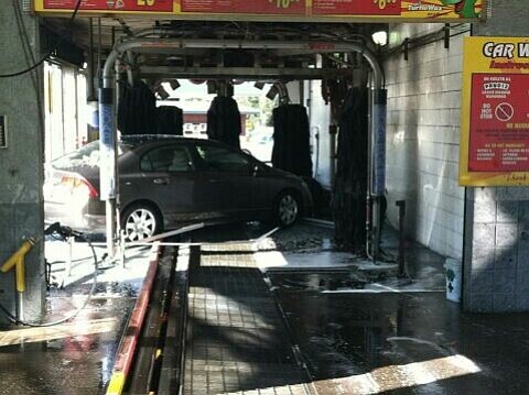 A car slammed into a car wash Thursday morning at a Shell station in east Vancouver .