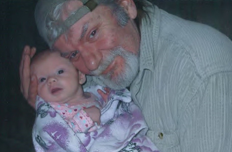 Chris Brewster holds his granddaughter in a photo taken before he was attacked in April 2015. Brewster, 55, of Vancouver died June 7 from his injuries.