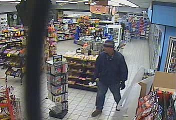 An armed man who escaped a Ridgefield convenience store with $52 Wednesday night remains on the loose.