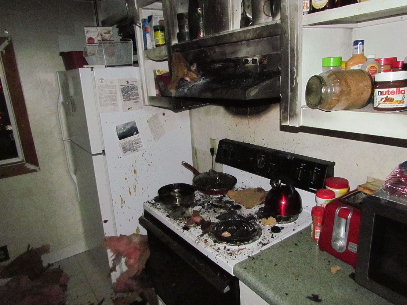 A stovetop fire spread after the occupant tried to use water to put out the flames, causing more than $8,000 in damage to a manufactured home.