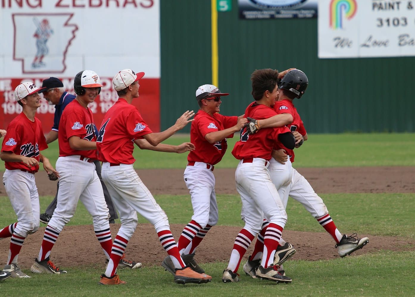 Hazel Dell Metro teammates congratulate Jasper Rank after his walk-off single scored Sam Lauderdale in Friday's 3-2 win over White Hall, Ark., in the Babe Ruth 14-Year-Old World Series.