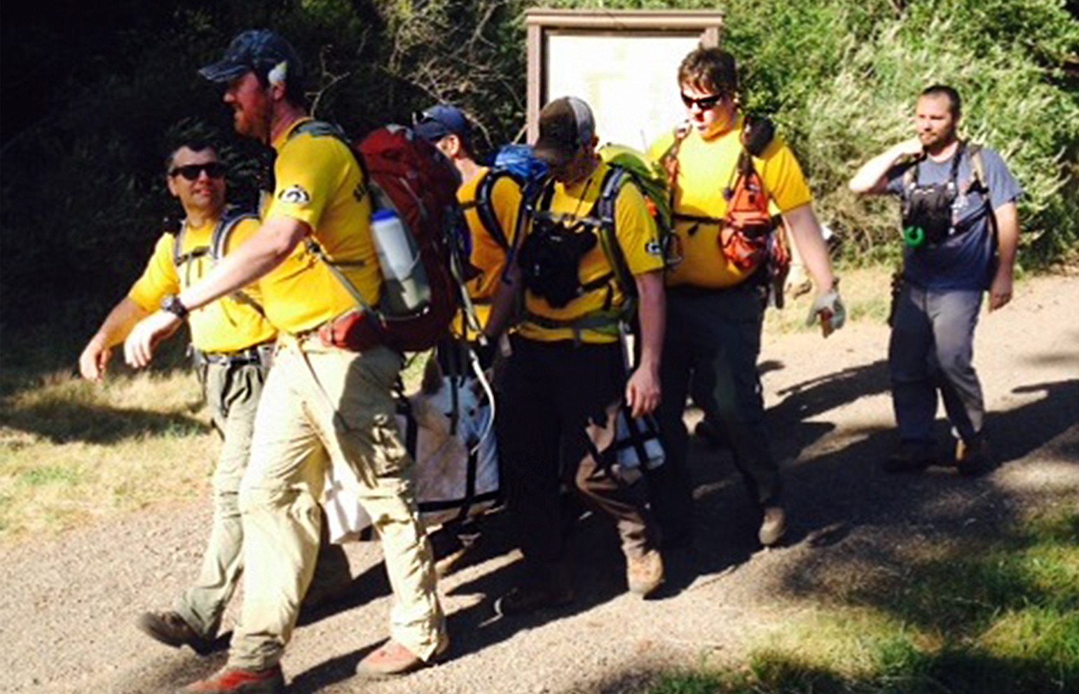 Emergency responders on Monday help carry a wounded dog to the trailhead on Dog Mountain.